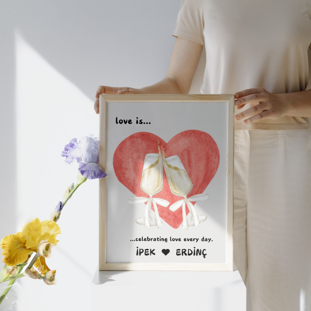 Tokuşturulan şampanya kadehleri ve "Celebrating love every day" yazılı kişiselleştirilmiş poster detay çekimi